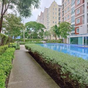 a swimming pool in a city with tall buildings at Condo Tulip Square at Aomnoi in Ban Khlong Om Noi