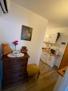 a kitchen with a table with a picture on the wall at Casa Tre Fiori 3 in Mignanego