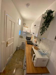 a kitchen with white cabinets and a counter top at Casa Tre Fiori 3 in Mignanego