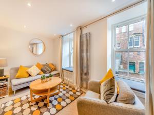 a living room with a couch and a table at Town Square House - Uk45610 in Alnwick