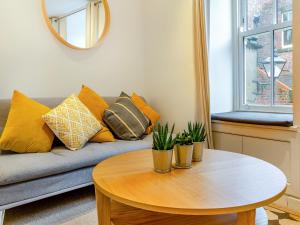 a living room with a couch and a table at Town Square House - Uk45610 in Alnwick
