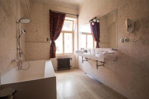 a bathroom with a sink and a shower and a mirror at Hotel Ebersbach in Český Krumlov +147 photos