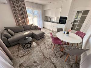 a living room with a couch and a table at Rooms & Apartment Jozić in Prozor