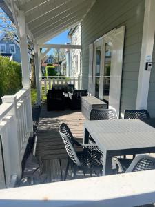 a wooden deck with a table and chairs on a house at Aquadelta - Casa Claudia in Bruinisse
