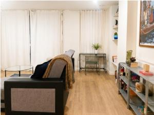 a living room with a couch and a table at Stunning 1 Bed Luxury Apartment in Erith