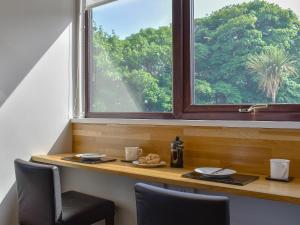 a table with a plate of food and a window at Woodlea Cottage 1 in Dippin +7 photos
