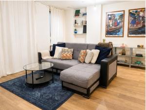 a living room with a couch and a table at Stunning 1 Bed Luxury Apartment in Erith +1 photo