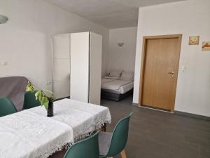 a room with a table and chairs and a bed at Obala 111 in Poljica
