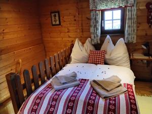 a bedroom with a bed with two towels on it at Chalet "Knusperhäuschen" in Murau