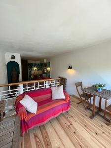 a living room with a couch and a table at La maison colimaçon in Clans