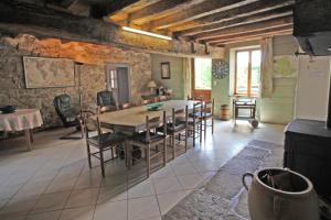 a kitchen and dining room with a table and chairs at Les cheyroux in Saint-Léger-Magnazeix