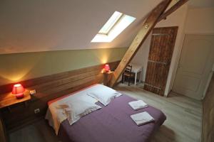 a bedroom with a bed and a skylight at Les cheyroux in Saint-Léger-Magnazeix +32 photos
