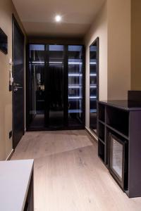 an empty room with glass doors and wooden floors at Sant'Angela Rooms in Foligno