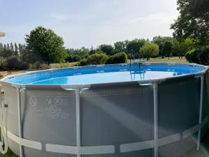 a large swimming pool with a cover around it at L'Oisette in Epiniac