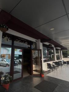 a restaurant with tables and chairs outside of a building at Hotel Ibiza in Eforie Nord