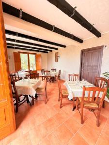 a dining room with tables and wooden chairs at Agriturismo Il Vecchio Carrubo in Castellammare di Velia
