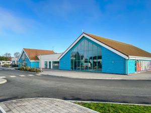 a blue building on the side of a street at Sunshine & Smiles in South Hayling