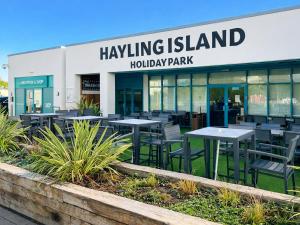 a group of tables and chairs in front of a building at Sunshine & Smiles in South Hayling +9 photos