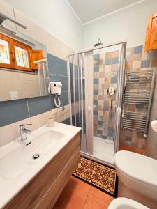 a bathroom with a white sink and a shower at Agriturismo Il Vecchio Carrubo in Castellammare di Velia +22 photos