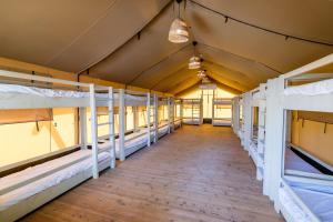 a row of bunk beds in a dorm room at Katzrin Village Glamping in Qasrîne