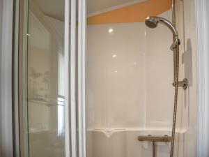 a shower with a glass door in a bathroom at Sandbank in Bacton +8 photos