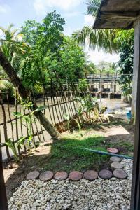 a garden with a fence and a path at River Island Villa in Ahangama