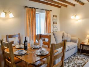 a living room with a table and a couch at Swaledale Cottag in Caldbeck