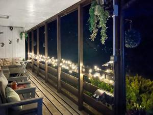 a room with a balcony with lights in the window at Harperfield Chalet in Lanark
