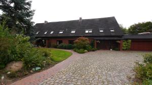 a house with a brick driveway in front of it at Natur pur in Neuhorst