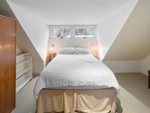 a bedroom with a bed and a window at Faodail in Plockton