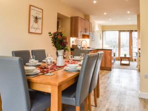 a dining room and kitchen with a table and chairs at Swan House in Carnforth