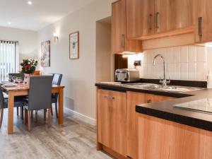 a kitchen with a table and a dining room at Swan House in Carnforth +23 photos