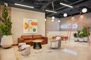 a lobby with a couch and a table and chairs at Blues Suites Medellín in Medellín