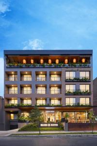 a large building with windows and plants on it at Blues Suites Medellín in Medellín