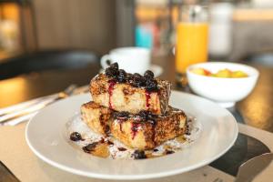 a white plate with a dessert on a table at Nodo Hotel in Manizales +72 photos