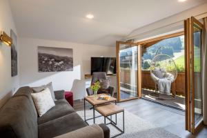 a living room with a couch and a table at Apartment Anita in Westendorf