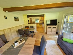 a living room with a table and a couch at Ferienhaus mit Bergblick am Wald in Stall
