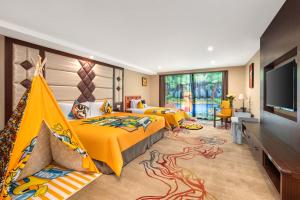 a bedroom with two beds and a flat screen tv at ShangHai LuAn Garden Hotel-Complimentary shuttle service between Shanghai Pu d ong Airport and Disneyland in Shanghai