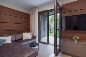 a living room with a couch and a television at Design Apartment Schladming in Schladming