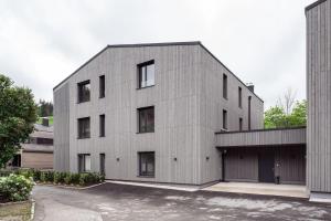 a large gray building with a garage at Design Apartment Schladming in Schladming