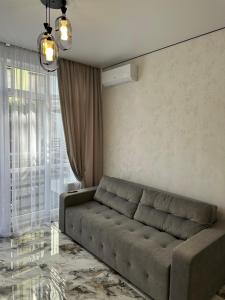 a living room with a couch in front of a window at SmartStudio in Odesa