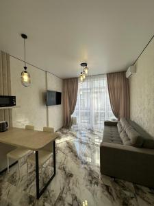 a living room with a couch and a table at SmartStudio in Odesa