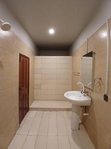 a bathroom with a sink and a shower at The Elet Express Luxury Hotel Apartments in Karachi