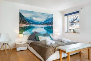 a bedroom with a large painting on the wall at Feriendomizil Brunnenberg in Sipplingen