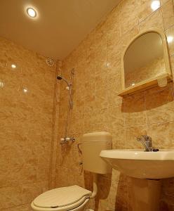 a bathroom with a toilet and a sink at Guest House Nash Dom in Kavarna +194 photos