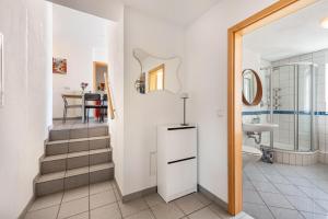 a bathroom with a toilet and a sink at Feriendomizil Brunnenberg in Sipplingen +26 photos