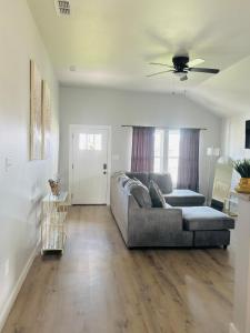 a living room with a couch and a ceiling fan at Tombstone Casa in Abilene