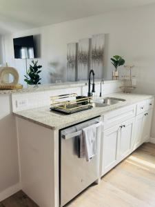 a kitchen with a sink and a dishwasher at Tombstone Casa in Abilene +55 photos