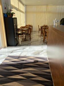 a dining room with wooden tables and chairs at Hotel Vanguarda Tapera in Tapera