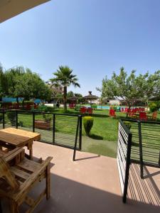 a park with a wooden table and a bench at La ferme labyed in Fez